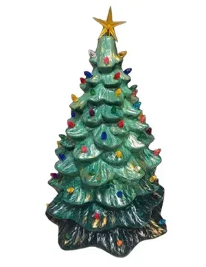 Decorated green Christmas tree figurine with multicolored ornaments and a gold star topper