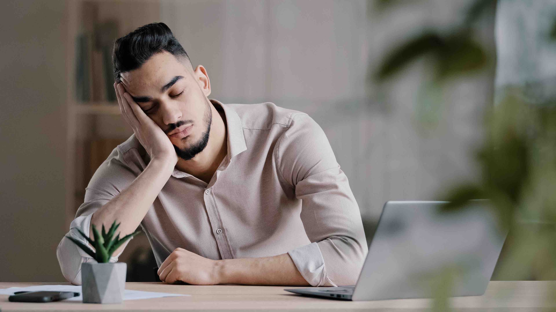 man sleeping at a desk