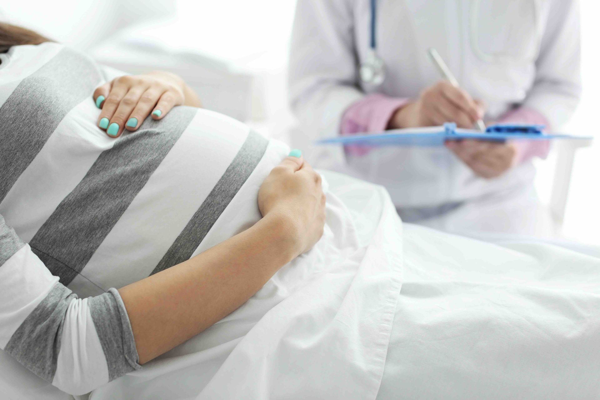 pregnant mother with her hand on her baby bump