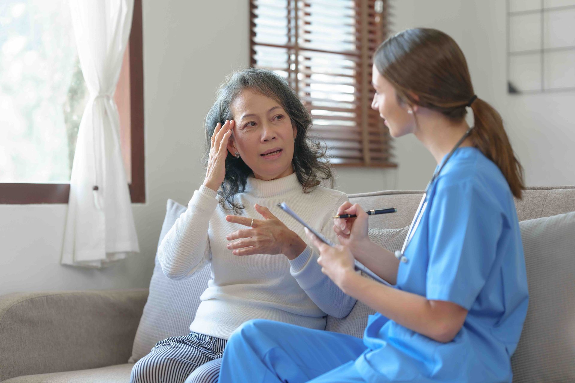 doctor talking with a lady who has migraines
