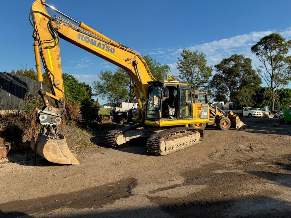 A Yellow Excavator is Digging the Dirt on a Construction Site — Lantry Earthmoving in Phoenix Park, NSW