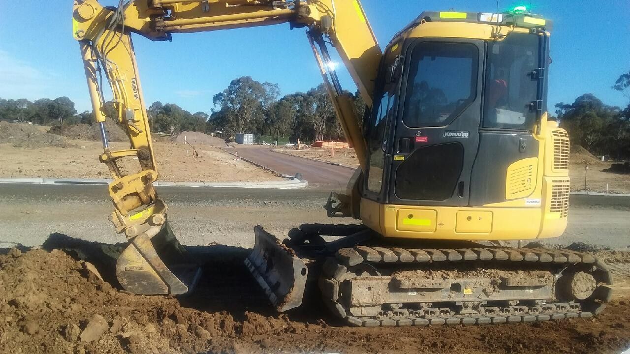 A Large Pile of Dirt is Being Scooped Up by an Excavator — Lantry Earthmoving in Phoenix Park, NSW