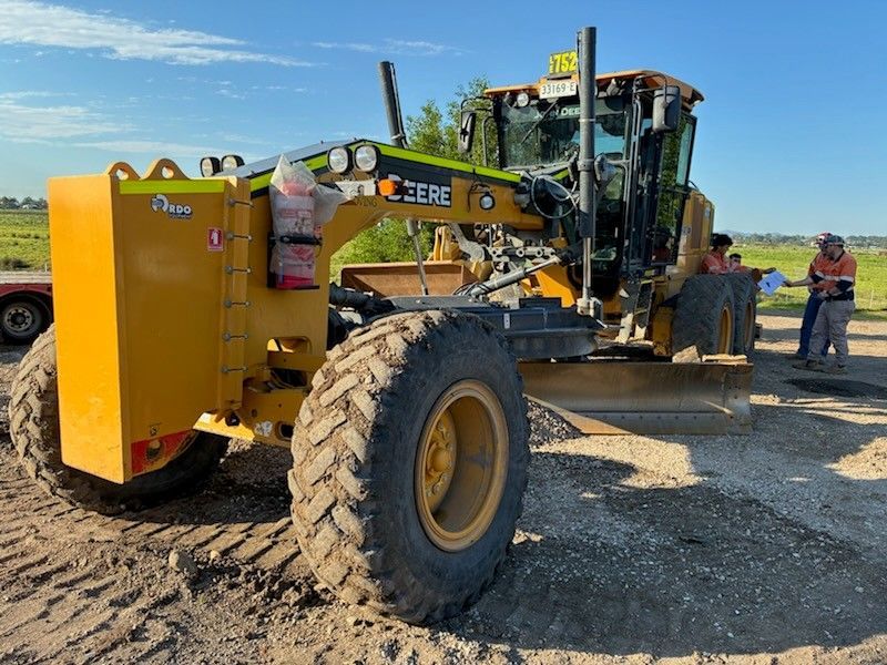 A Bulldozer is Moving Dirt on a Dirt Road — Lantry Earthmoving in Phoenix Park, NSW