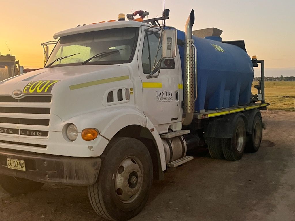 A Water Truck with a sunset — Lantry Earthmoving in Phoenix Park, NSW