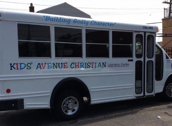 White Kids' Avenue Christian bus parked outdoors with 