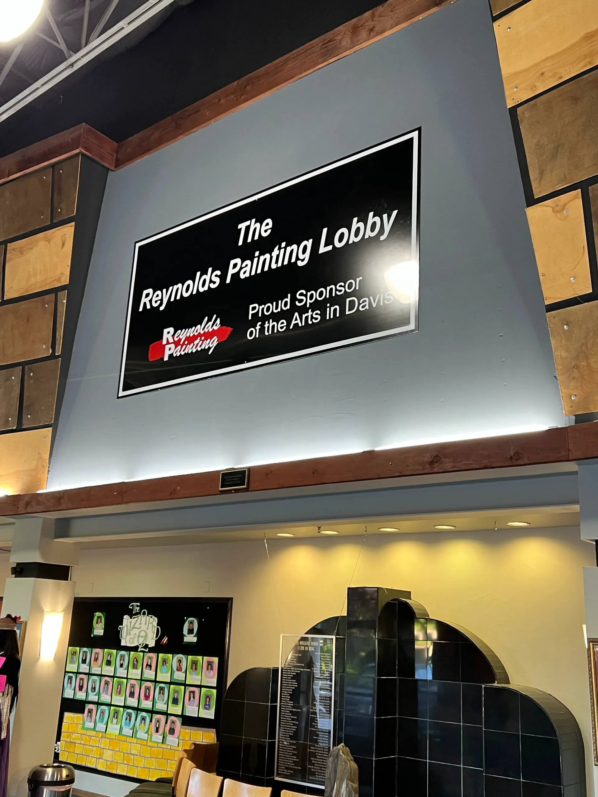 Sign for The Oregonian’s Pounding Lobby above a colorful, tiled wall inside a building