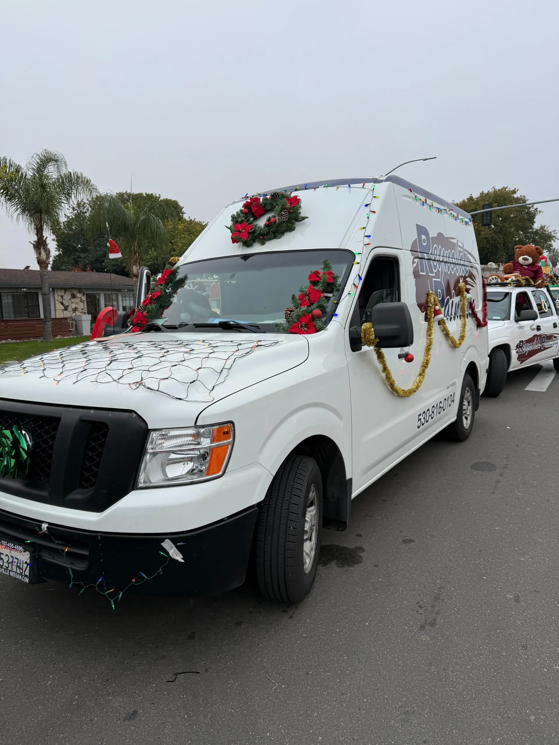 White pickup truck decorated with flowers and garlands in a street parade