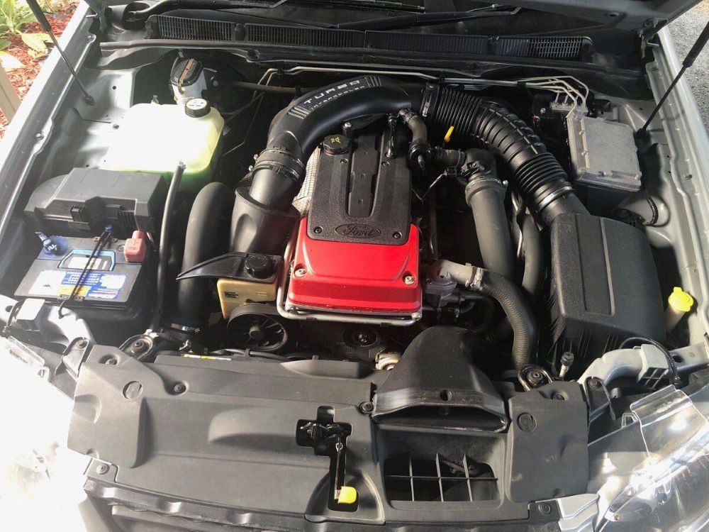 A Close Up of a Car Engine With the Hood Open — Mick Dunn Motor Repairs in Mackay, QLD