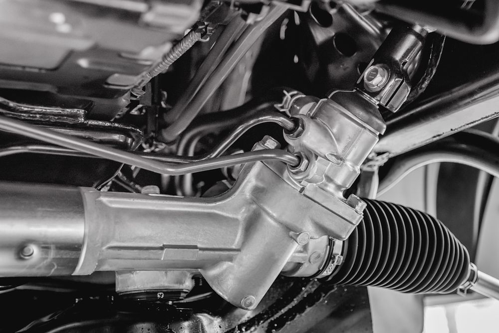A Black and White Photo of a Steering Rack on a Car — Mick Dunn Motor Repairs in Mackay, QLD
