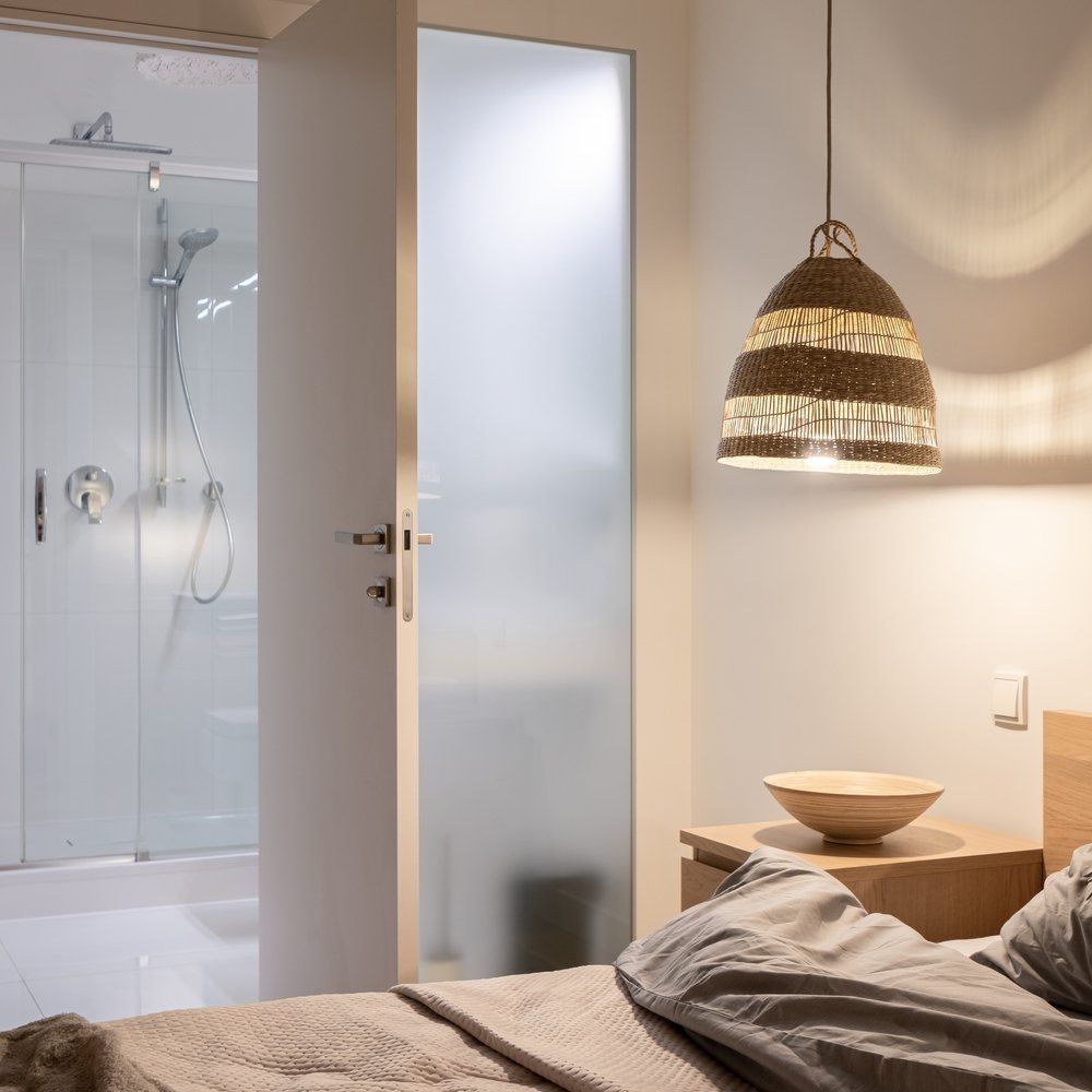 A Bedroom with A Bed and A Bowl on A Nightstand — Coastline Glass Pool Fencing in Taree, NSW
