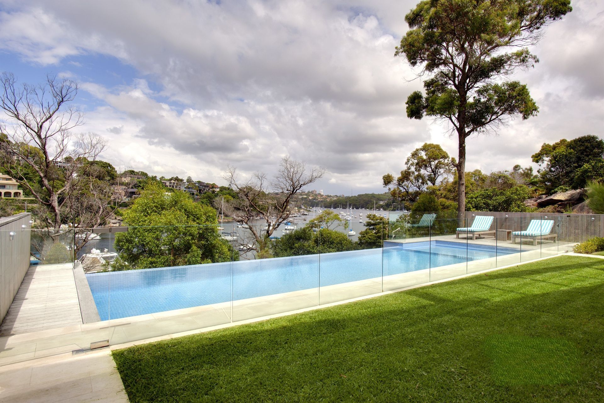 An Infinity Swimming Pool Overlooking a Calm Bay — Coastline Glass Pool Fencing in Old Bar, NSW