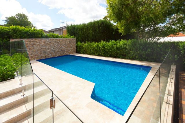A Balcony with A Table and Chairs and A View of A City — Coastline Glass Pool Fencing in Old Bar, NSW