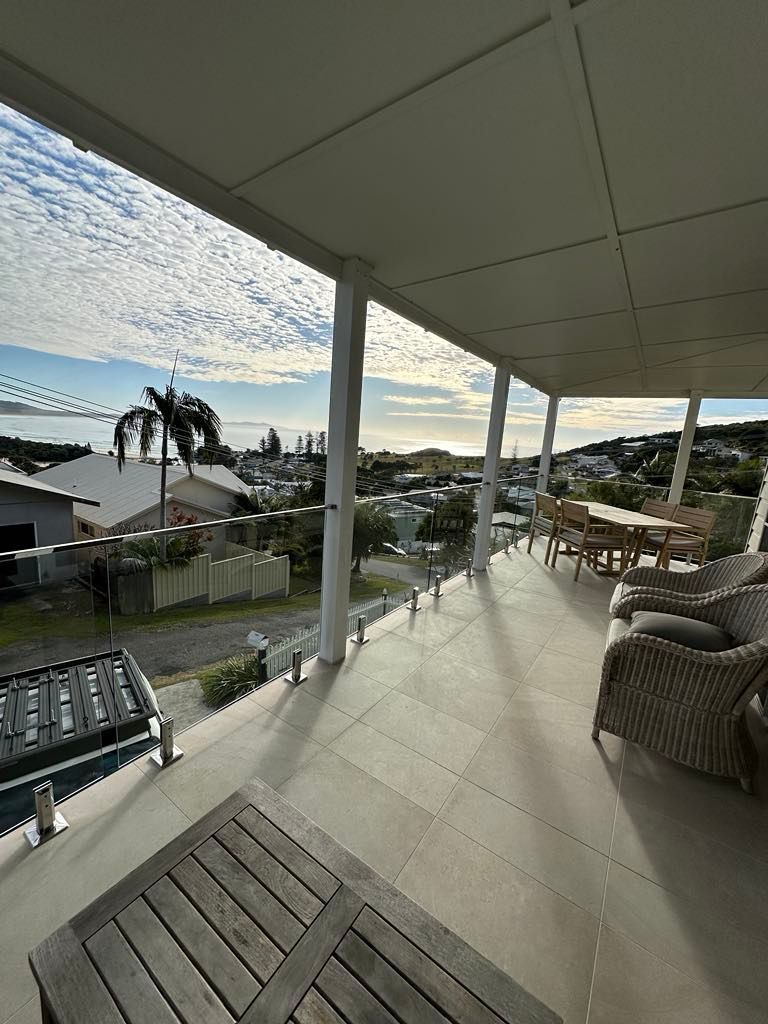 A Balcony with A Stainless Steel Railing and Clear Glass — Coastline Glass Pool Fencing in Gloucester, NSW