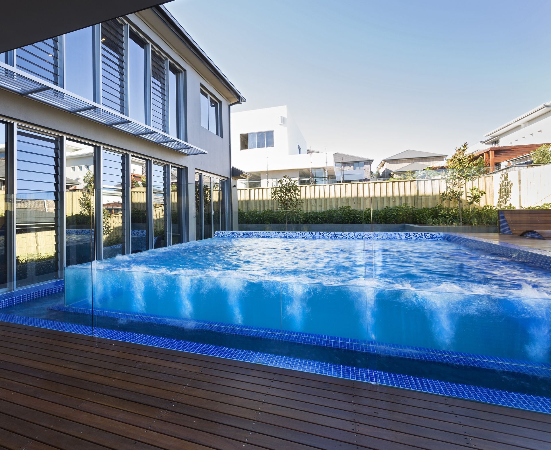 A Modern Home with An Outdoor Swimming Pool — Coastline Glass Pool Fencing in Old Bar, NSW