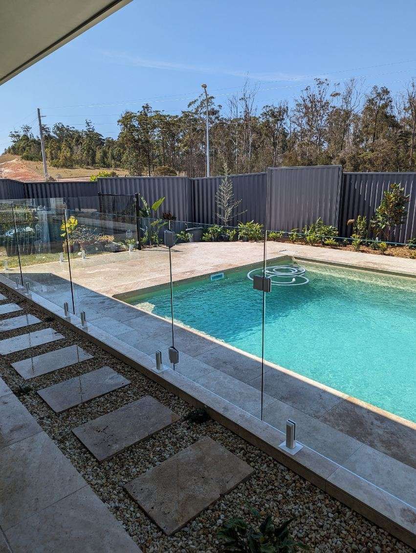 A House with A Swimming Pool in Front of It — Coastline Glass Pool Fencing in Old Bar, NSW
