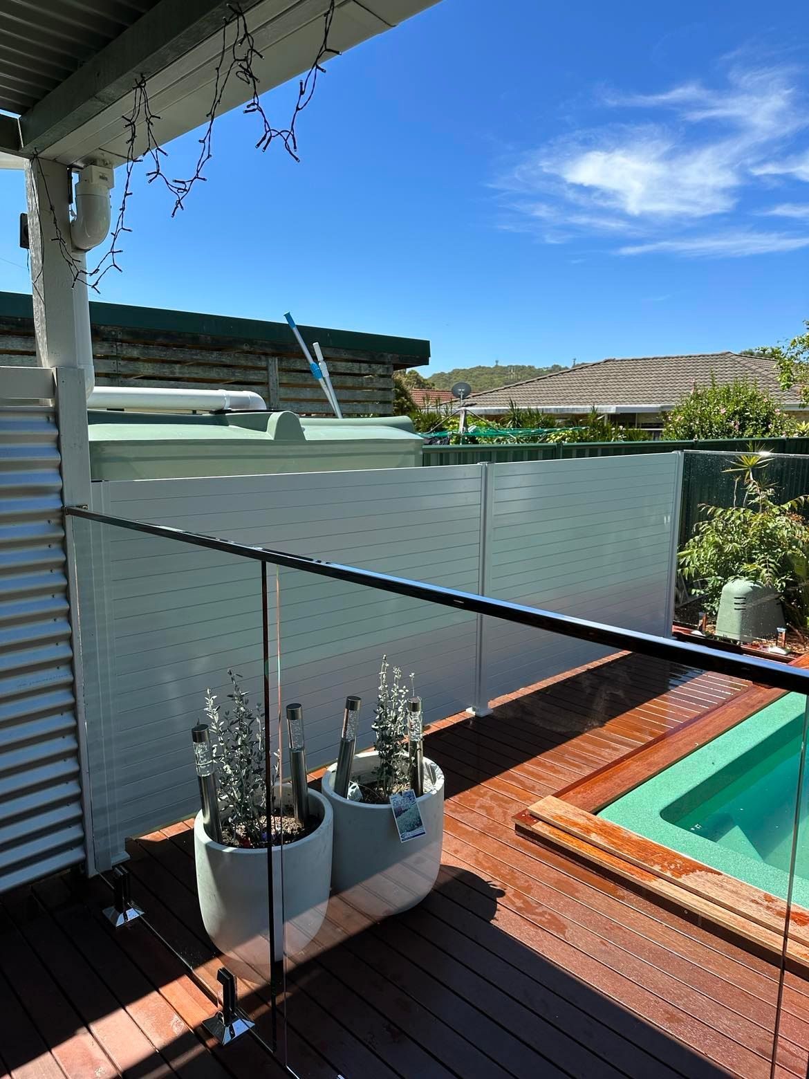 A Large Swimming Pool with A Glass Fence Around It — Coastline Glass Pool Fencing in Old Bar, NSW