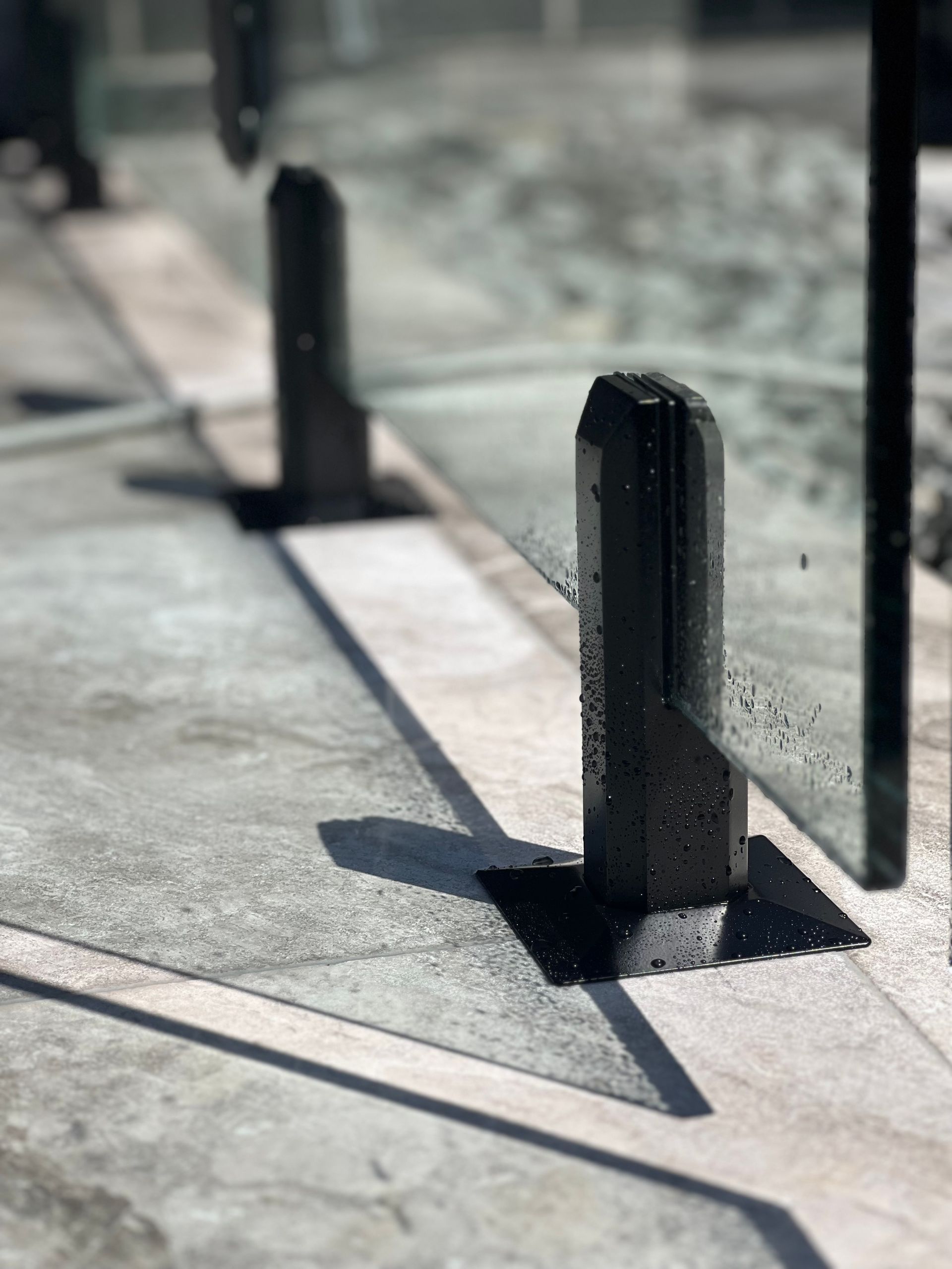 A Close Up of a Glass Fence With a Shadow on the Ground — Coastline Glass Pool Fencing in Old Bar, NSW