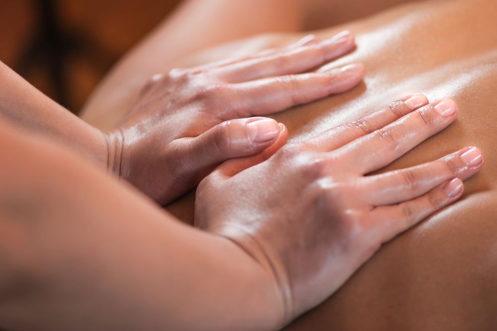 A Woman is Getting a Massage With Her Hands on Her Back — Siam Thai Massage In Tweed Heads, NSW