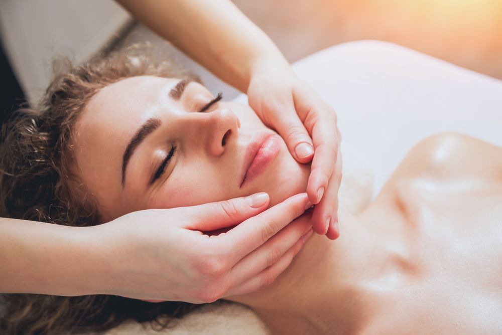 A Woman is Getting a Facial Massage at a Spa — Siam Thai Massage In Tweed Heads, NSW