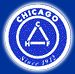 Blue circular Chicago logo with white triangle icon and “Chicago” text around the edge