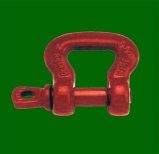 Red metal shackle on a green background