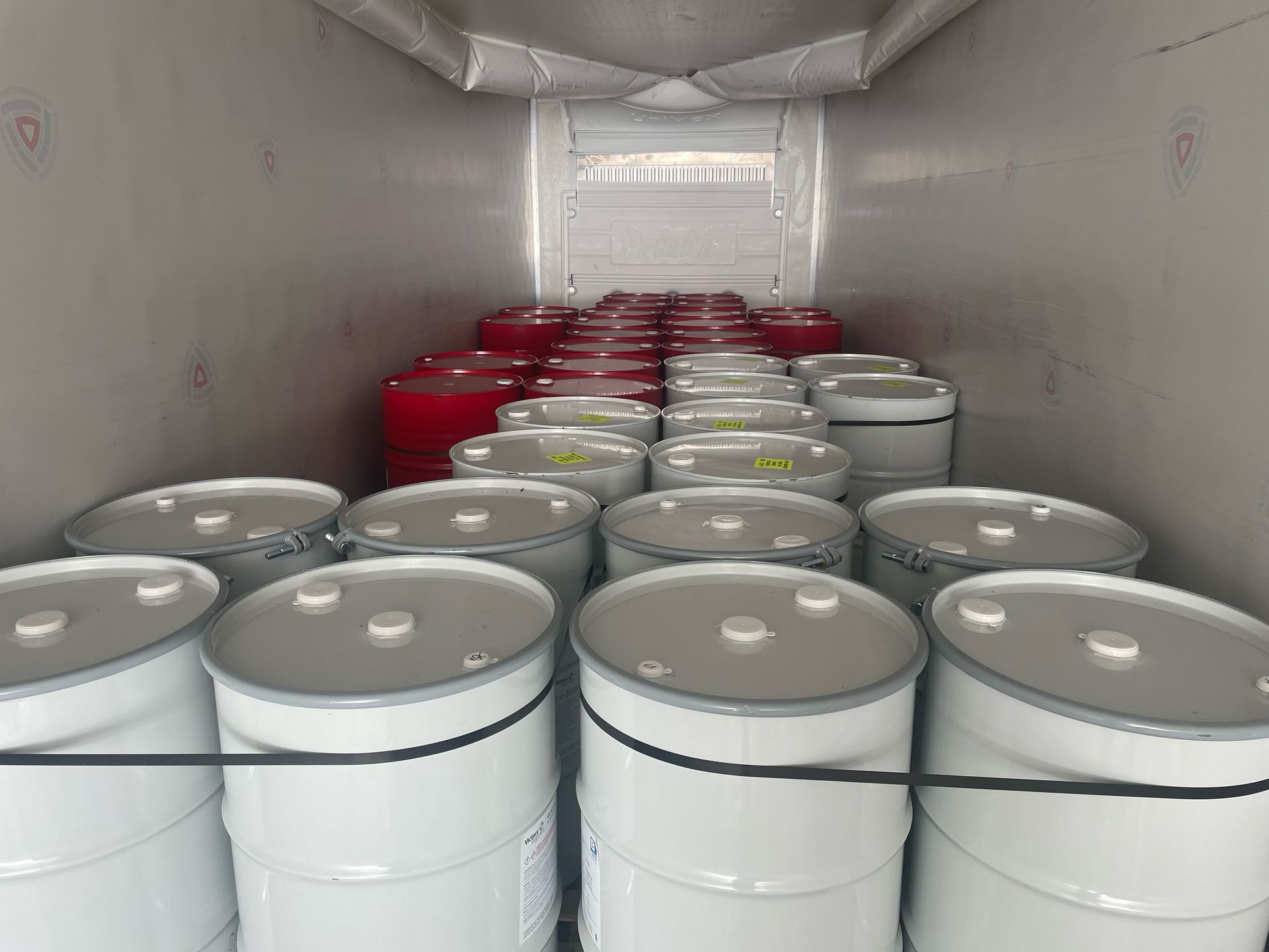 A bunch of barrels are stacked on top of each other in a truck