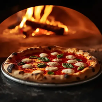 Pizza baking in a wood-fired oven, topped with mozzarella, basil, and tomato sauce