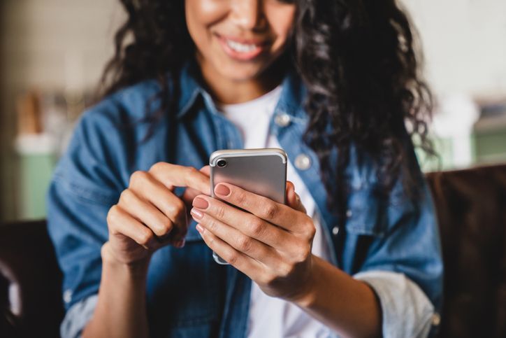 woman using smart phone at home