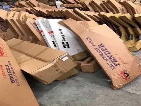 A pile of cardboard boxes sitting on top of each other in a warehouse.