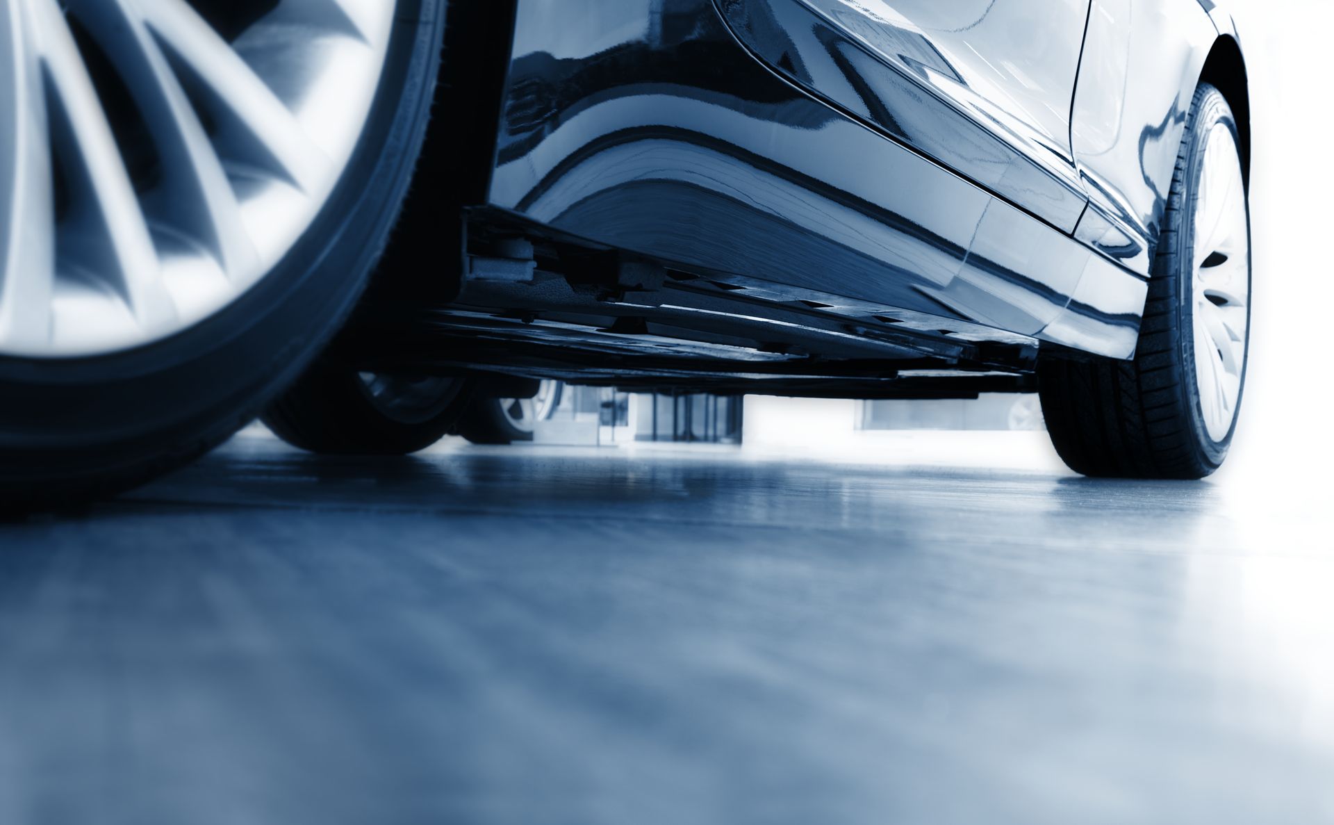 A car is parked on a concrete floor in a garage.