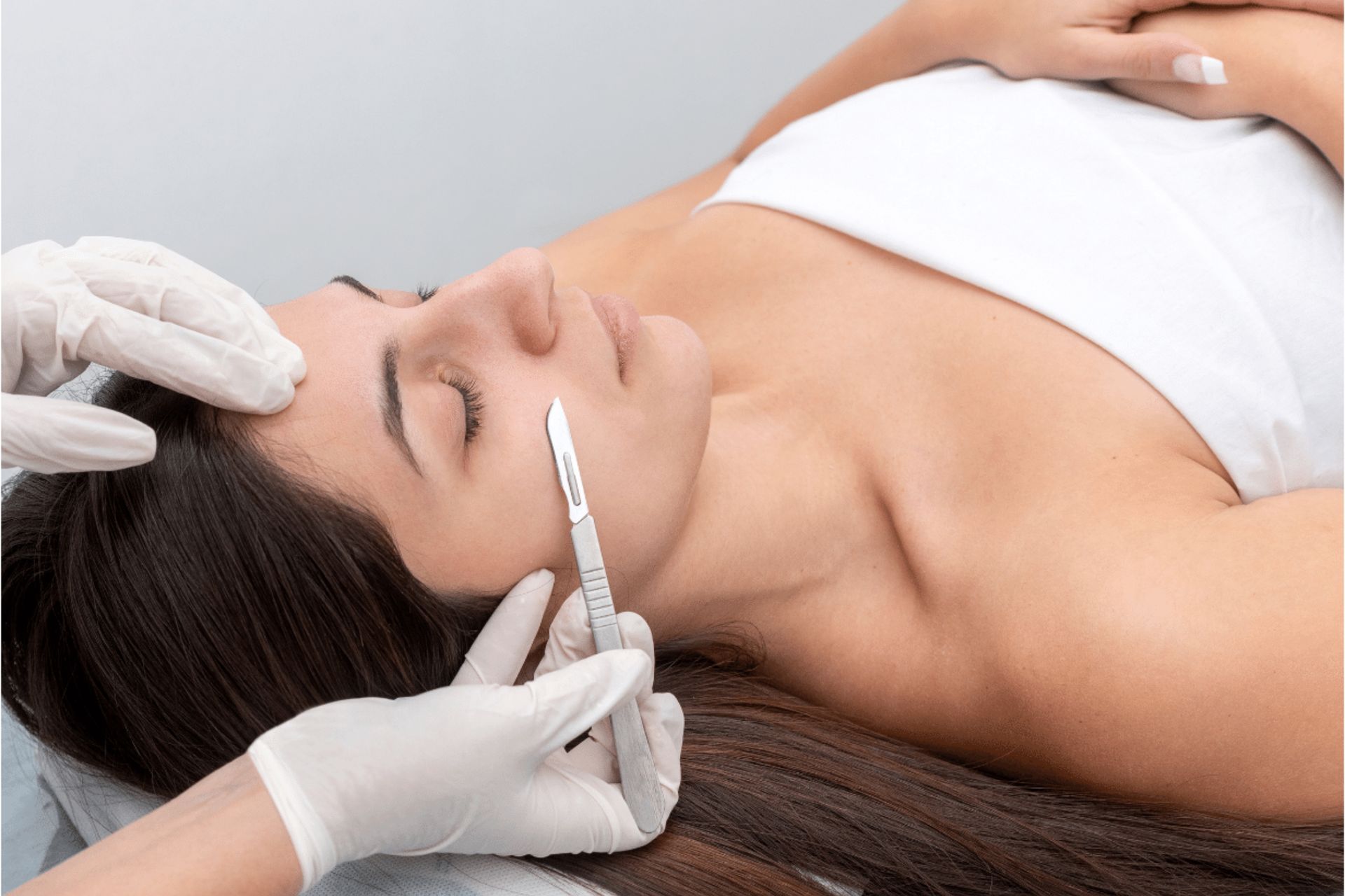 Close-up of a person receiving an eyebrow injection treatment from gloved hands