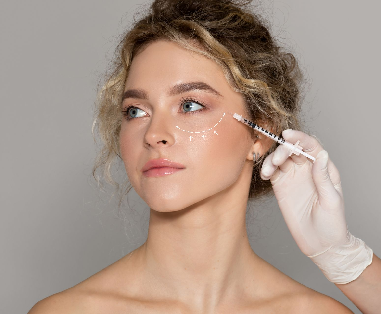 Woman receiving cosmetic injections to reduce wrinkles on her face.