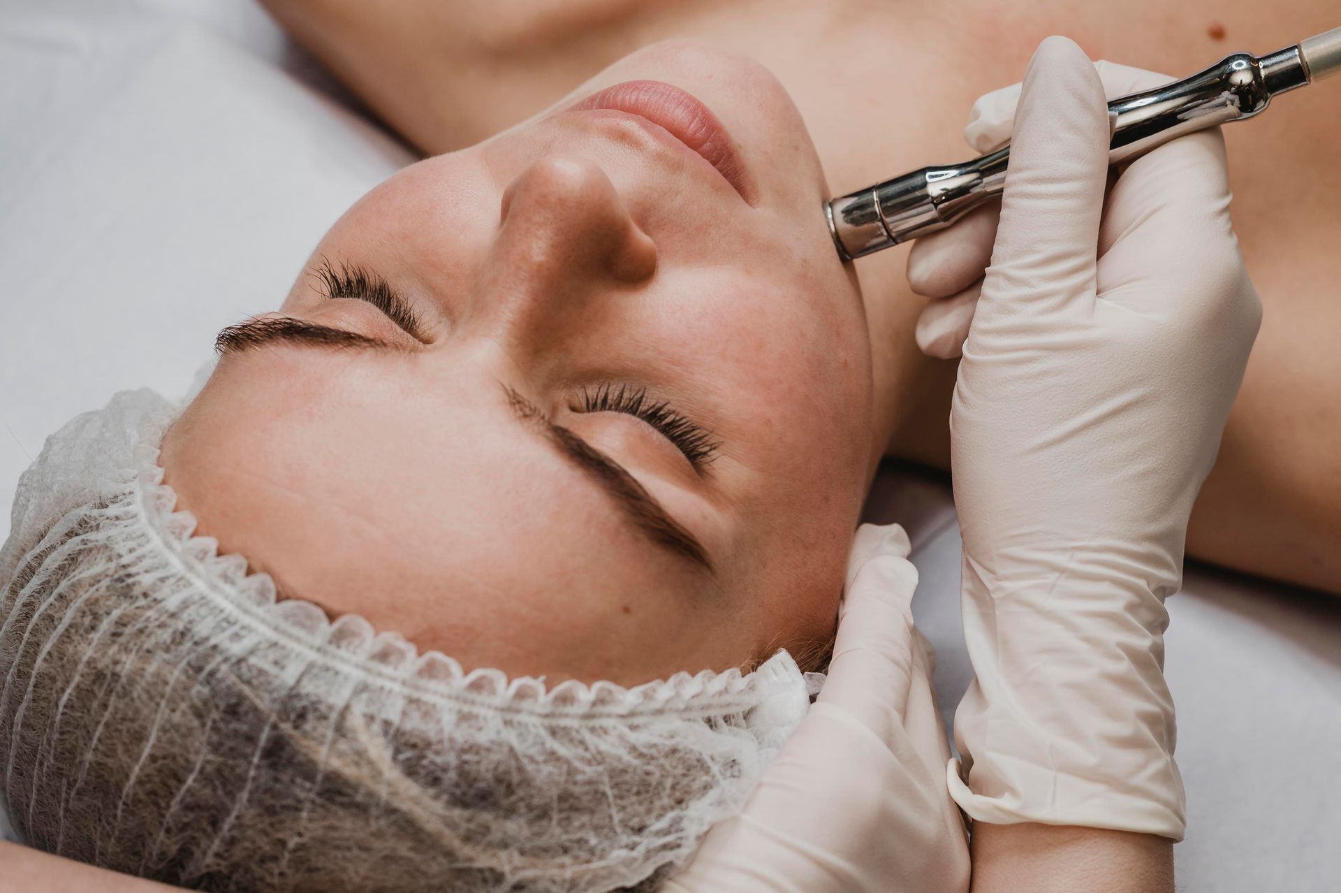 Cosmetic injection being administered to a client’s face in a spa treatment setting