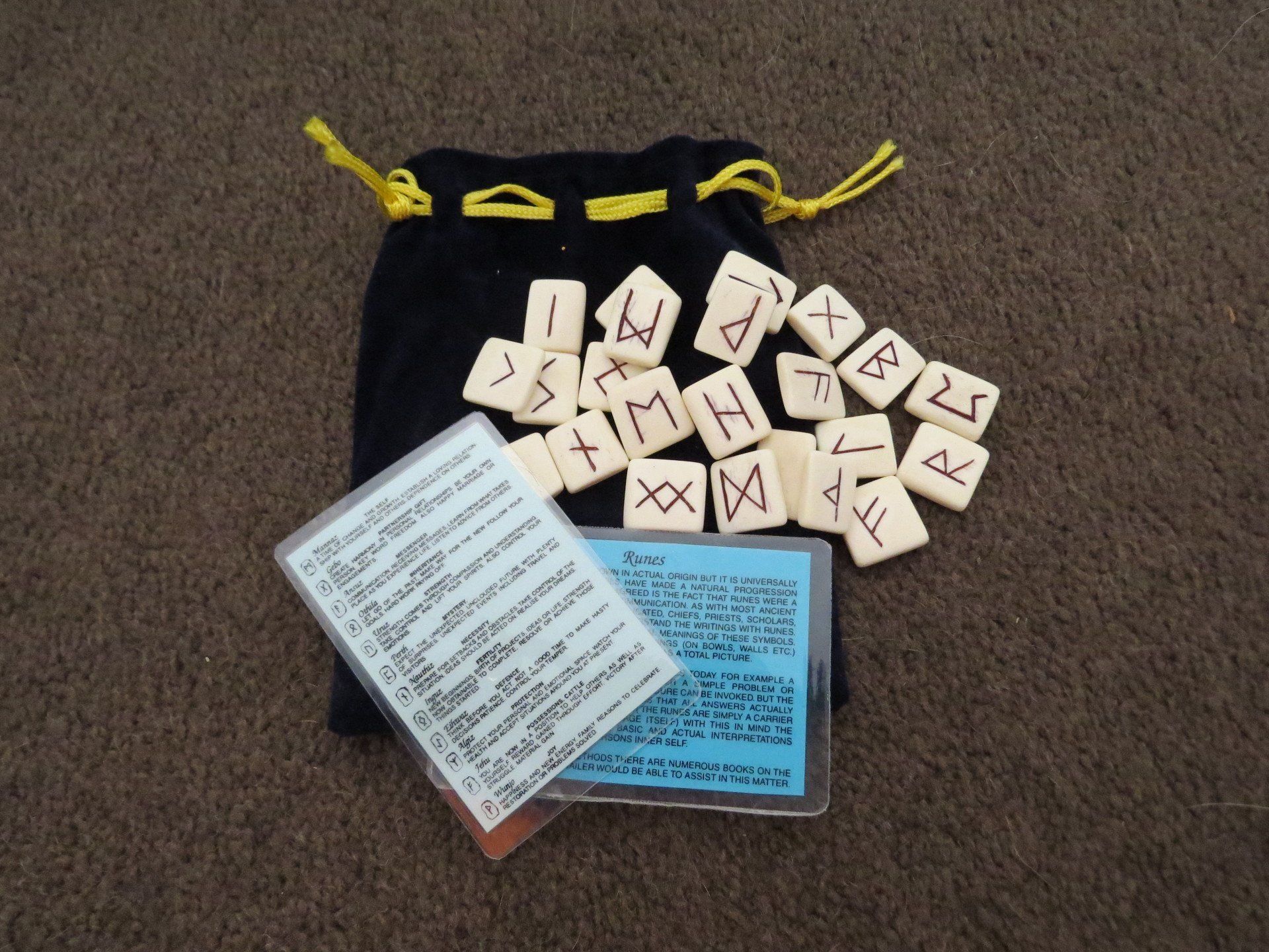 A bag filled with runes and a booklet