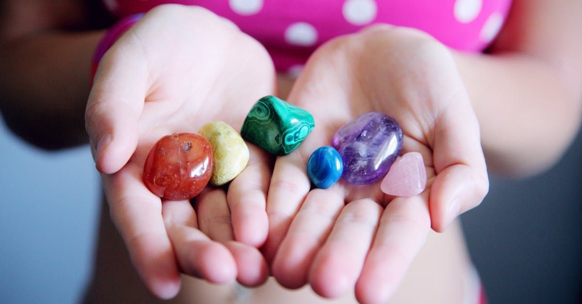A woman is holding a bunch of stones in her hands.