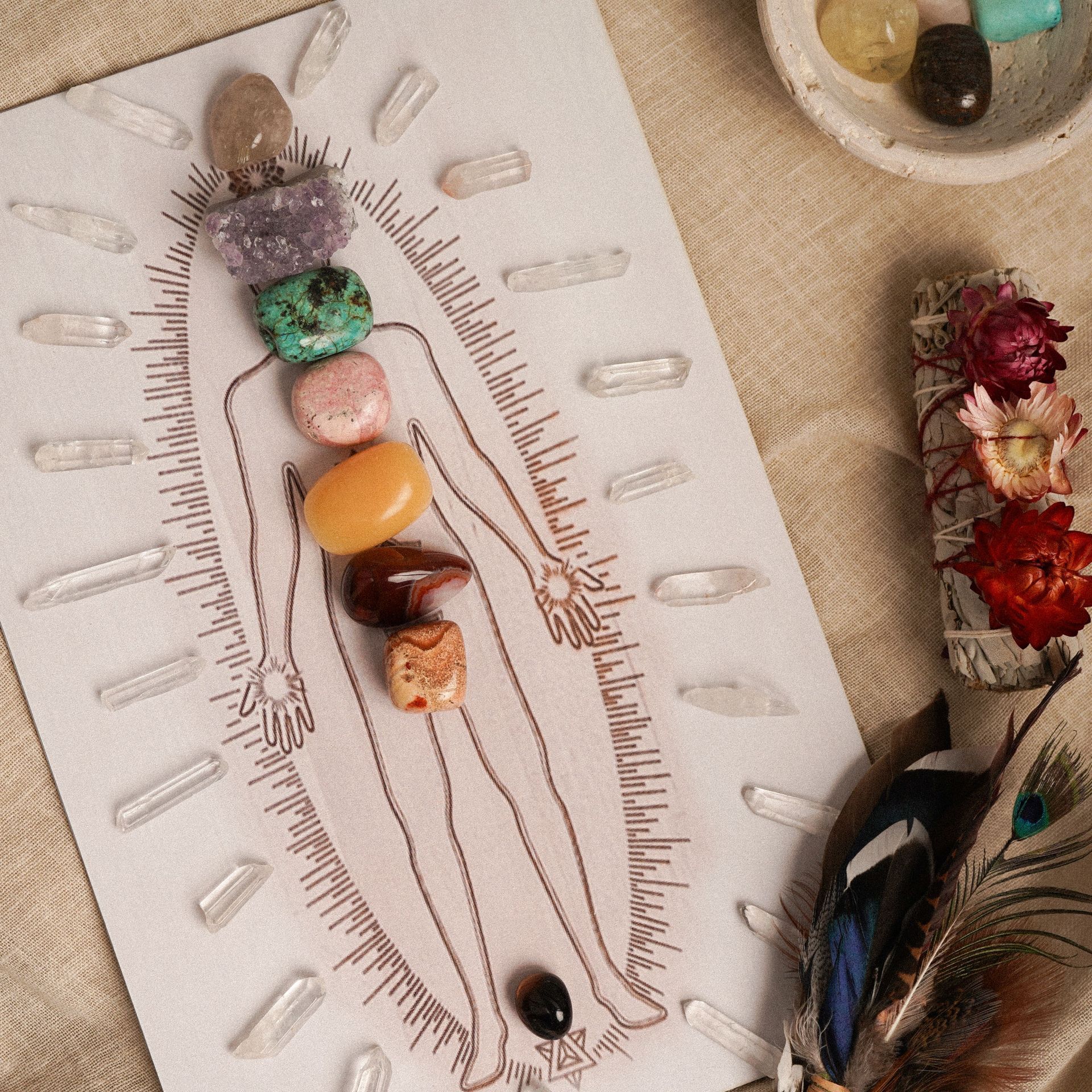 Boho handmade illustration with crystals and feathers on a white paper figure outline