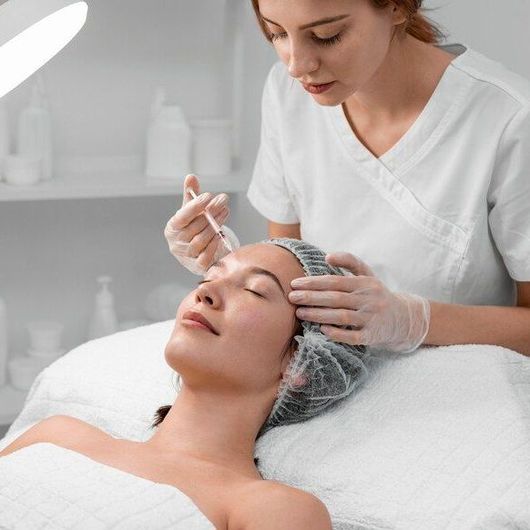 a woman is getting a facial treatment at a beauty salon .