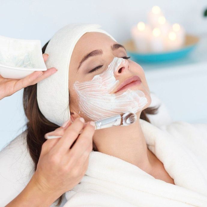 a woman is getting a facial treatment at a spa