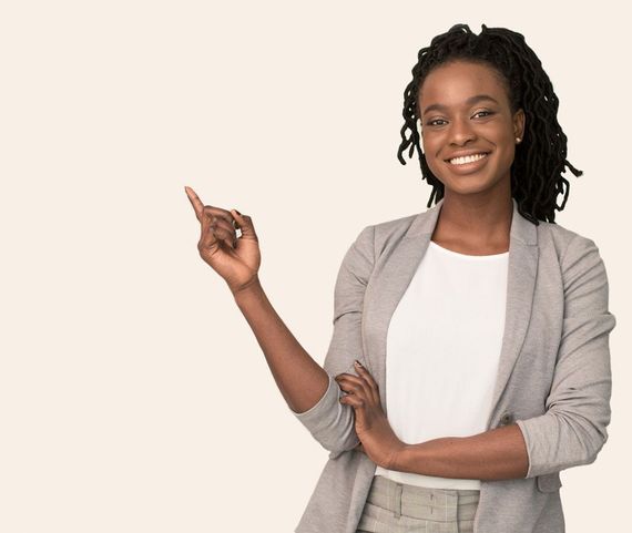 A woman is smiling and pointing up with her finger.