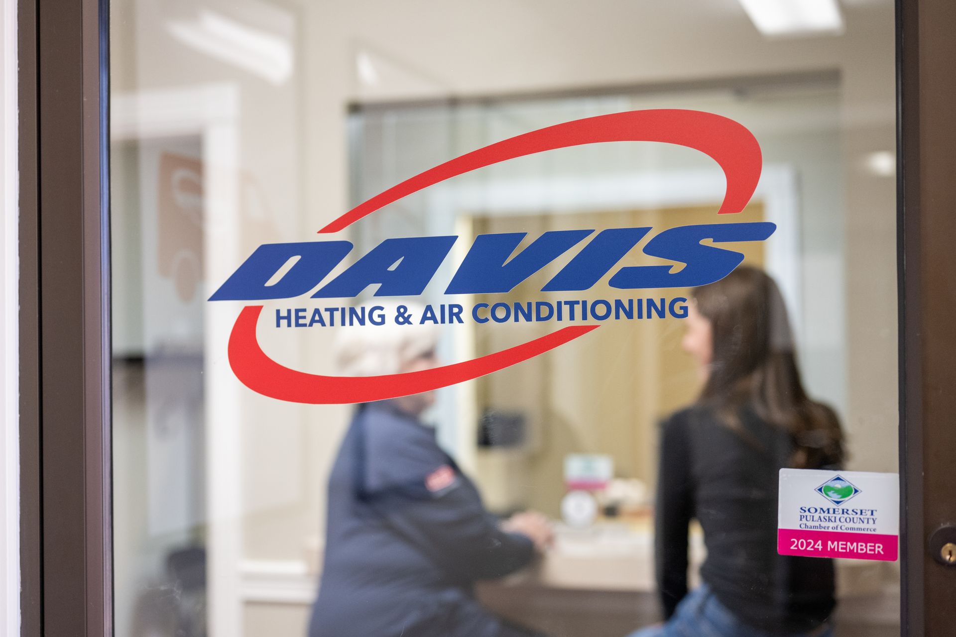 Two women sitting inside of a Davis heating and air conditioning store.