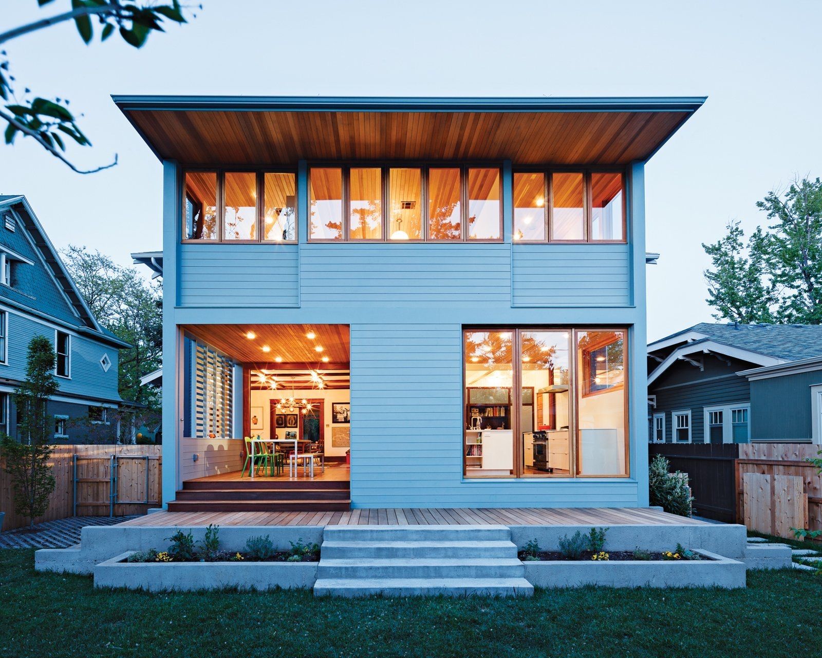A blue house with a lot of windows and stairs
