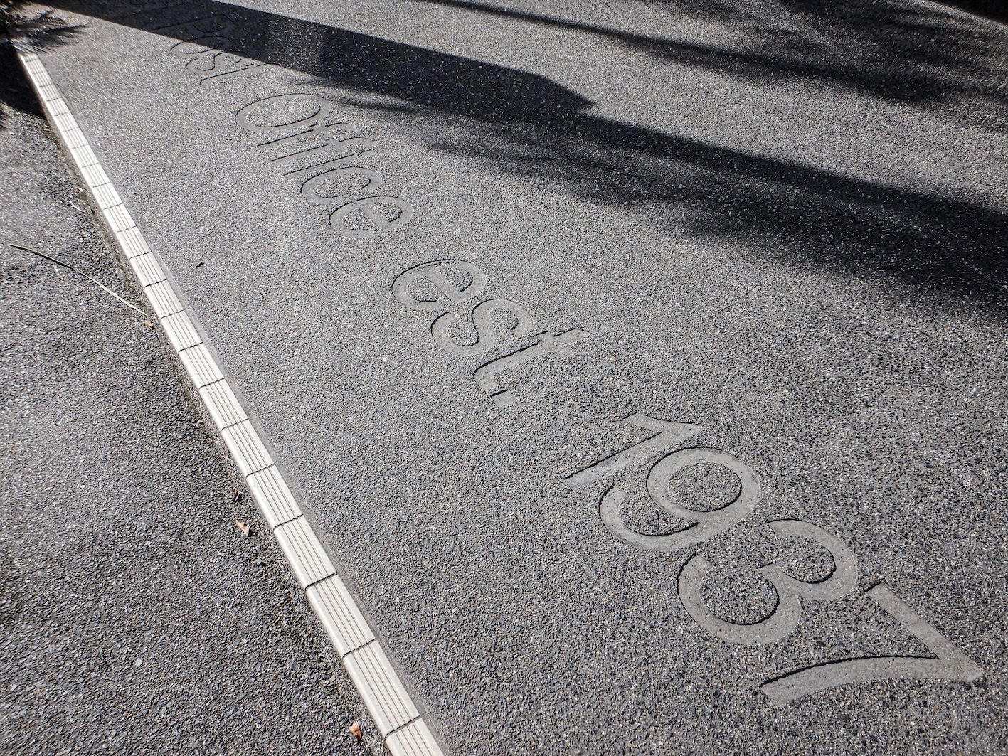 Historic marking along Abott Street walkway — one of the small but meaningful details you discover when exploring Cairns on foot.