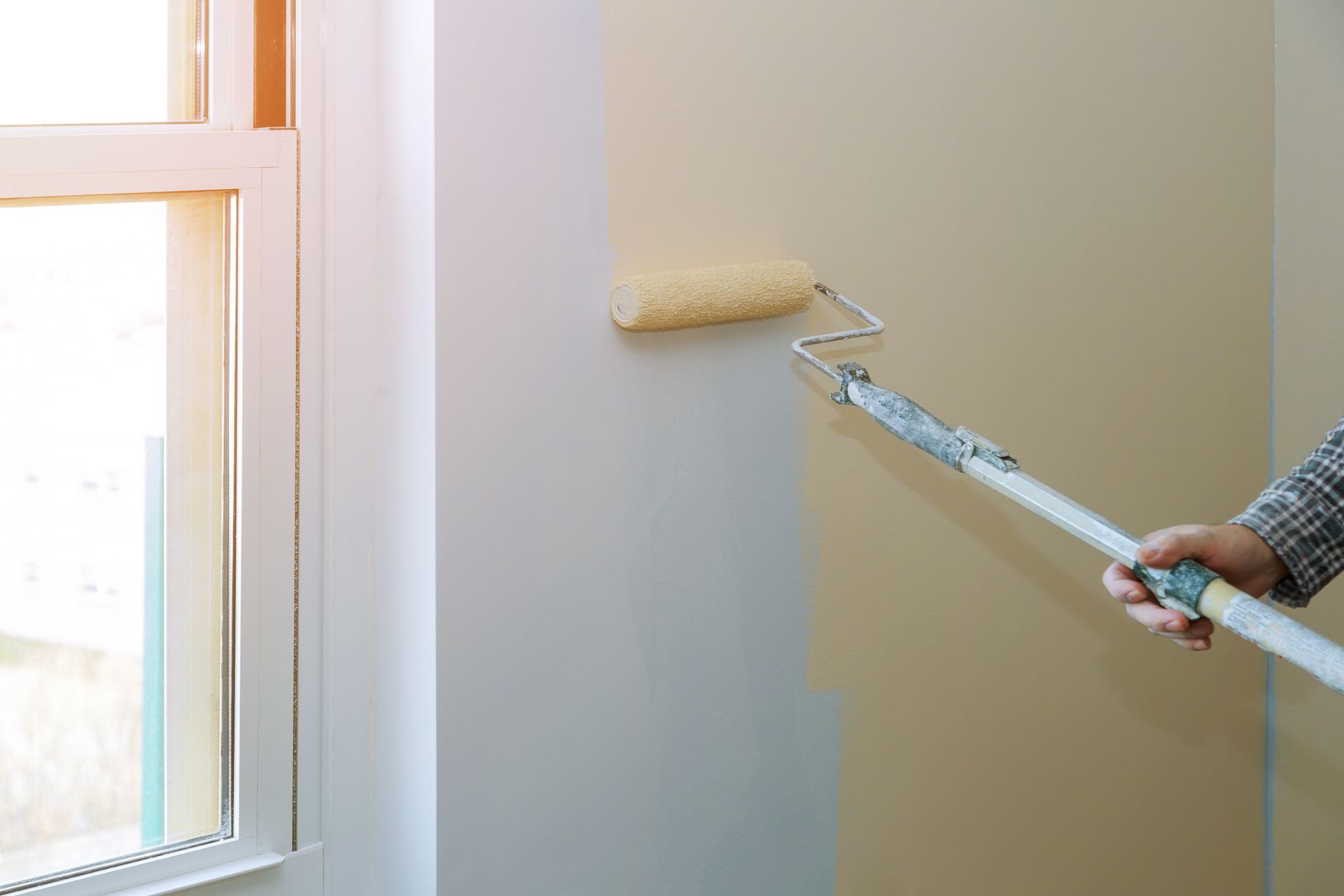 Professional interior wall painting with a roller by Pure Excellence Painting and Powerwashing