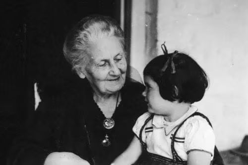 Dr. Maria is sitting next to child.
