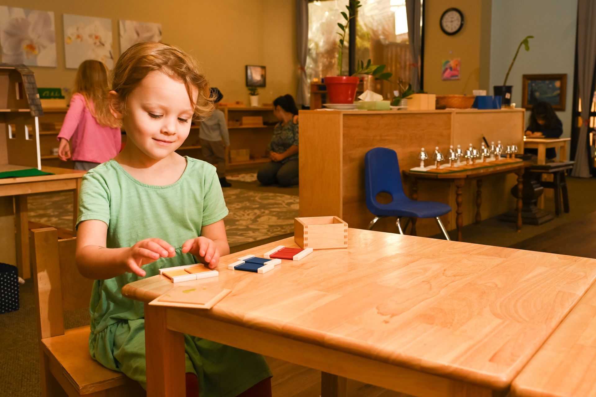 Montessori child working with coloured tablets