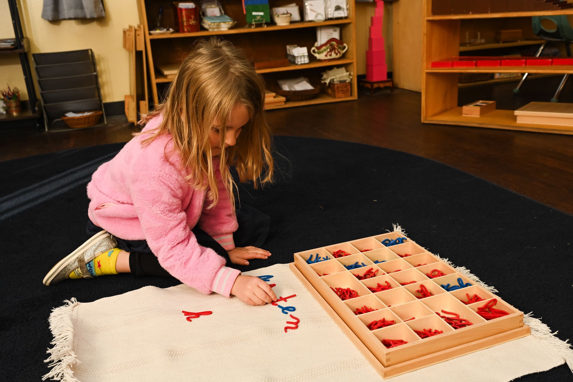 Montessori child working with the movable alphabet.
