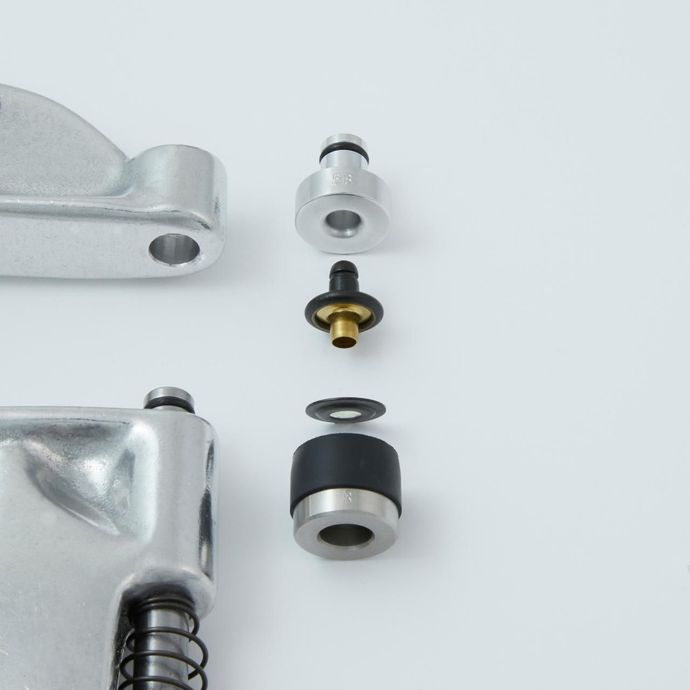 Exploded view of a mechanical component with metal and rubber parts.