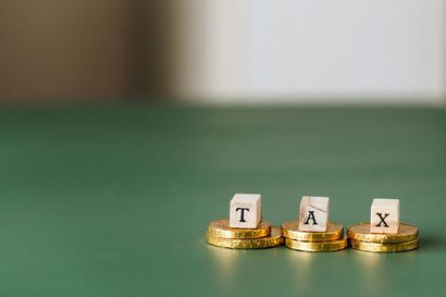 Gold coins supporting wooden blocks spelling 
