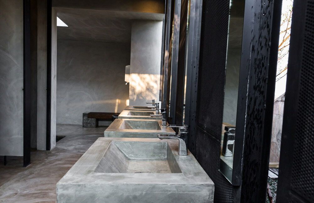 Long Concrete Sinks Beneath a Dark Modern Corridor With Sunlight Streaming in — JAJ Plumbing in Mount Austin, NSW