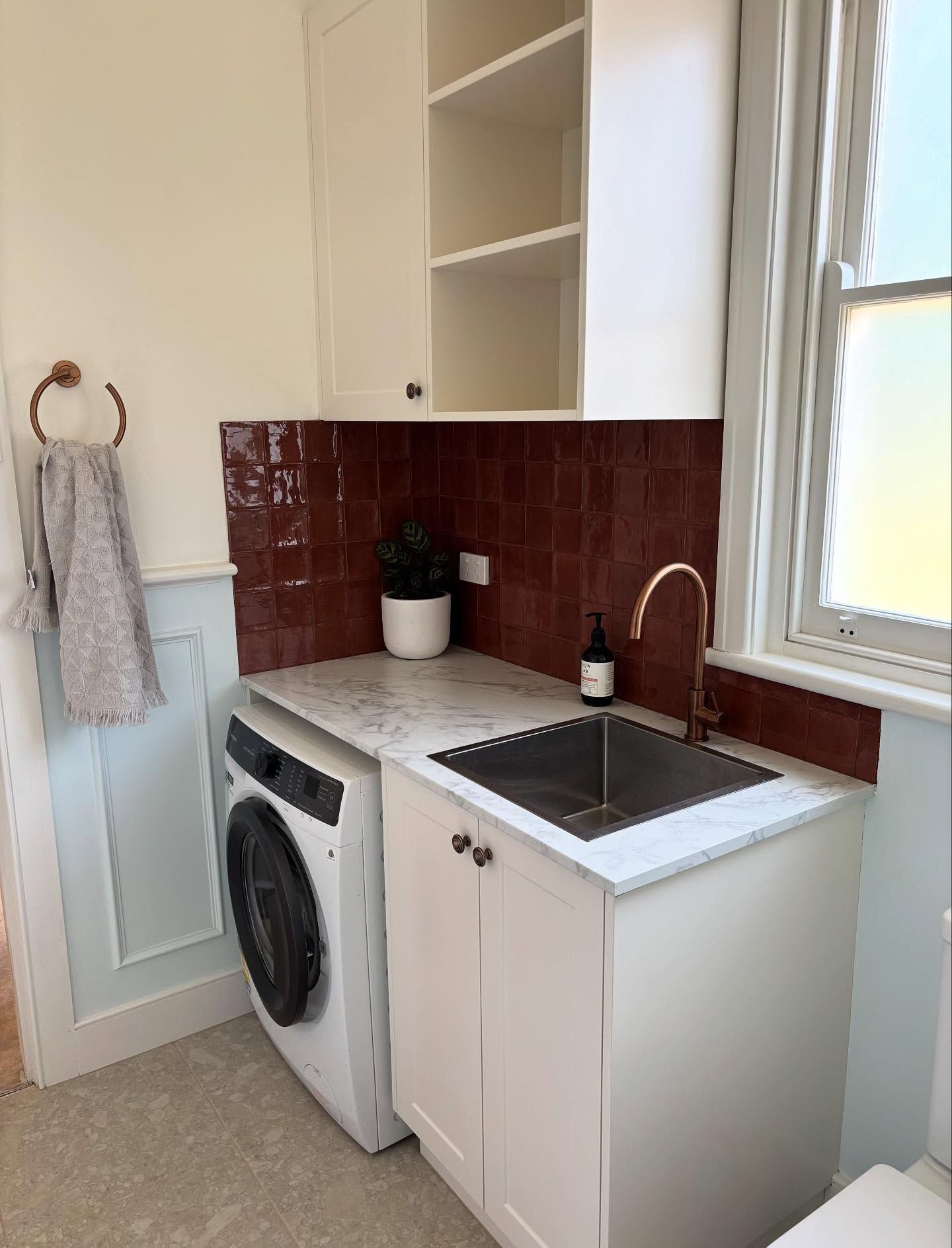 Compact Laundry Room With White Washer, Sink, Red Tile Backsplash — JAJ Plumbing in Mount Austin, NSW